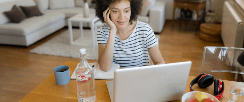 A woman at home, presumably attending a virtual conference